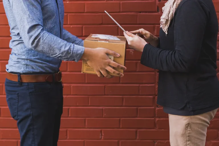Courier handing a parcel to a business client