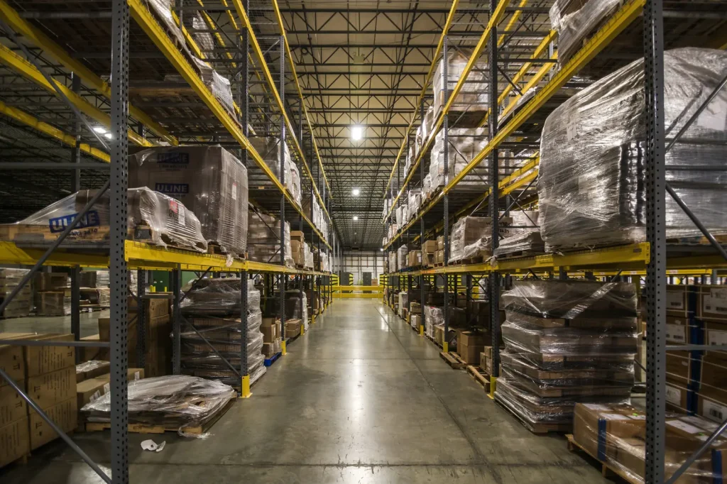 Fulfillment warehouse aisle with stocked shelves