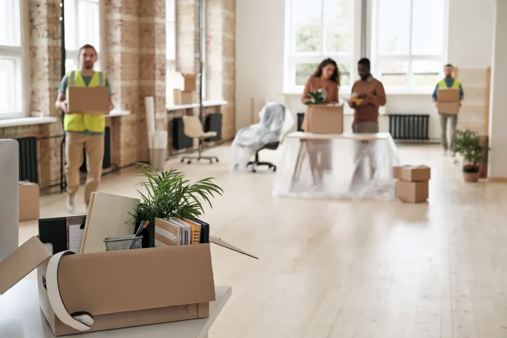 Office relocation team packing and moving boxes