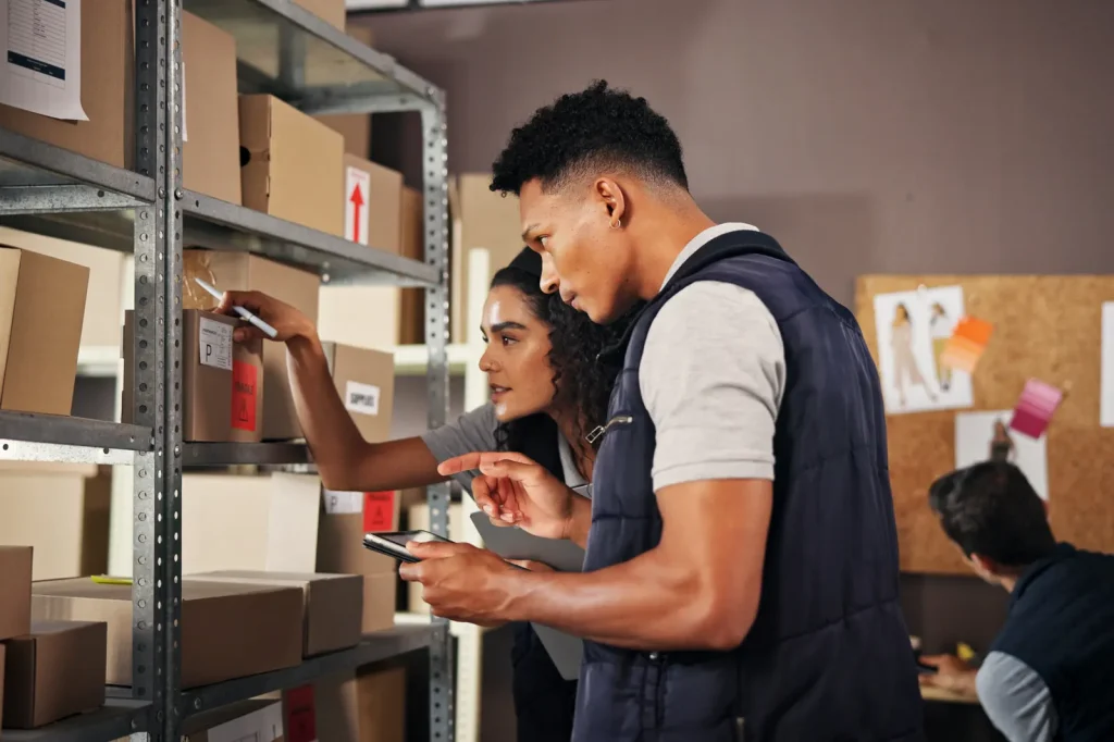 Warehouse team checking inventory on a tablet
